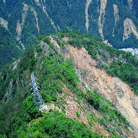 由921地震所造成的稜線至溪谷大規模崩塌地不僅對道路形成衝擊，也對台灣電力公司的發電與輸配電設施產生威脅。照片中的崩塌地使高壓電塔岌岌可危。