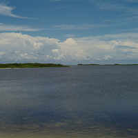 在夏季時，由於東沙島水氣充沛，對流發展旺盛。潟湖遠方可看到大片積雨雲正在發展，預估不久的午後會降下對流雨。