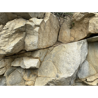 花岡岩的節理。花岡岩受節理控制，形成破碎岩塊，有些氧化鐵附著其上，偏橘紅。從照片上，可看到兩組接近垂直的節理。