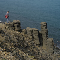 A visitor standing on the basaltic columns
